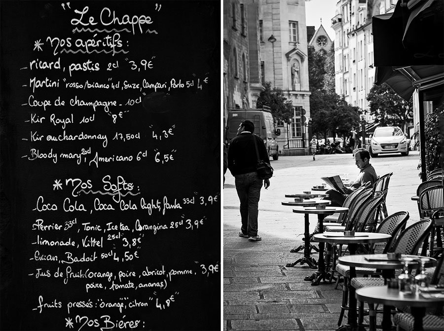 Vyriškis skaitantis laikraštį Paryžiaus kavinėje